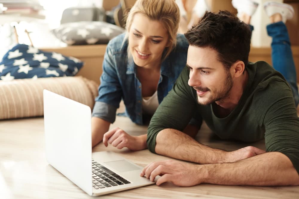 Couple planning their move early on a laptop computer